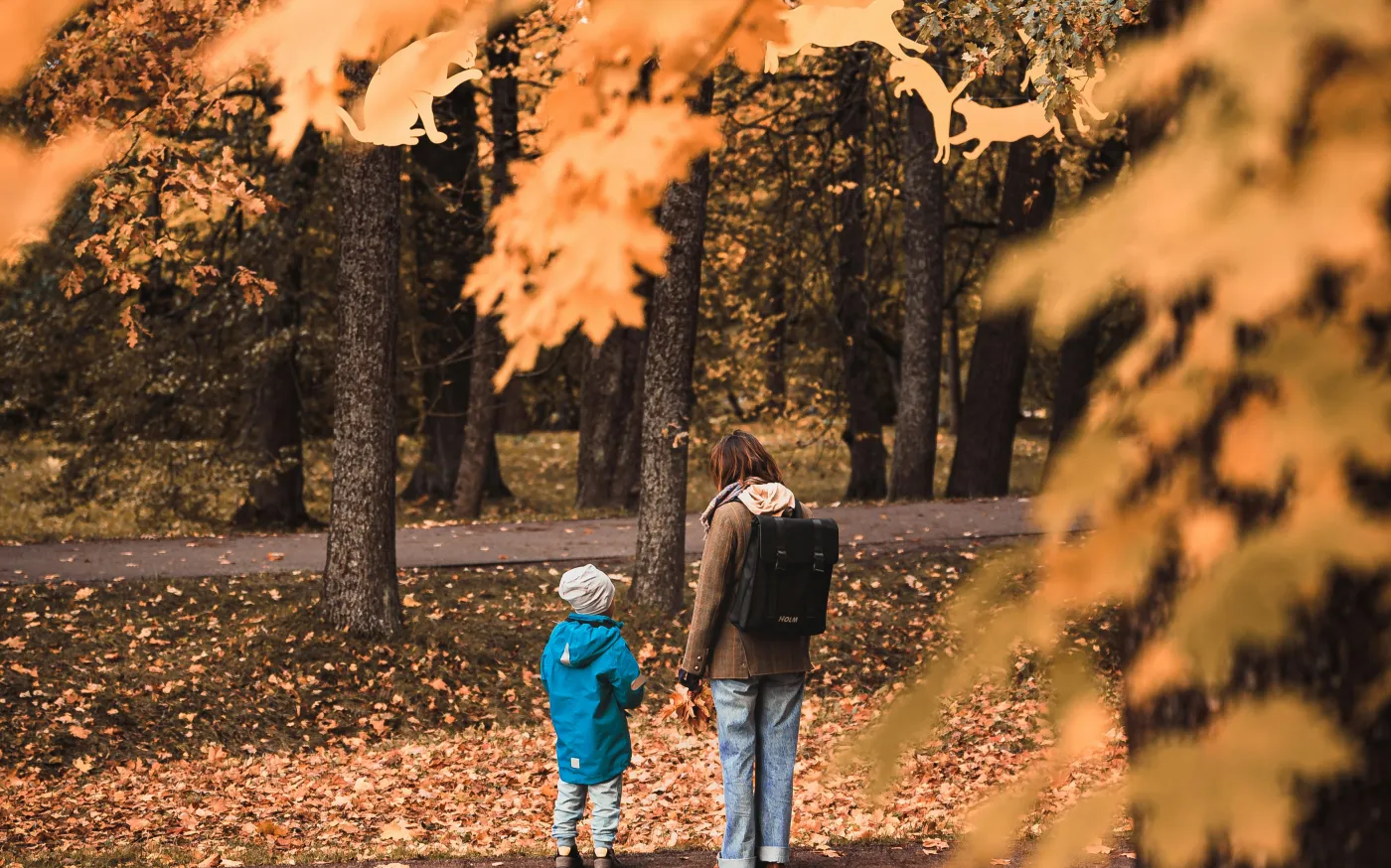A man and a child walking through a park by E I courtesy of Unsplash.