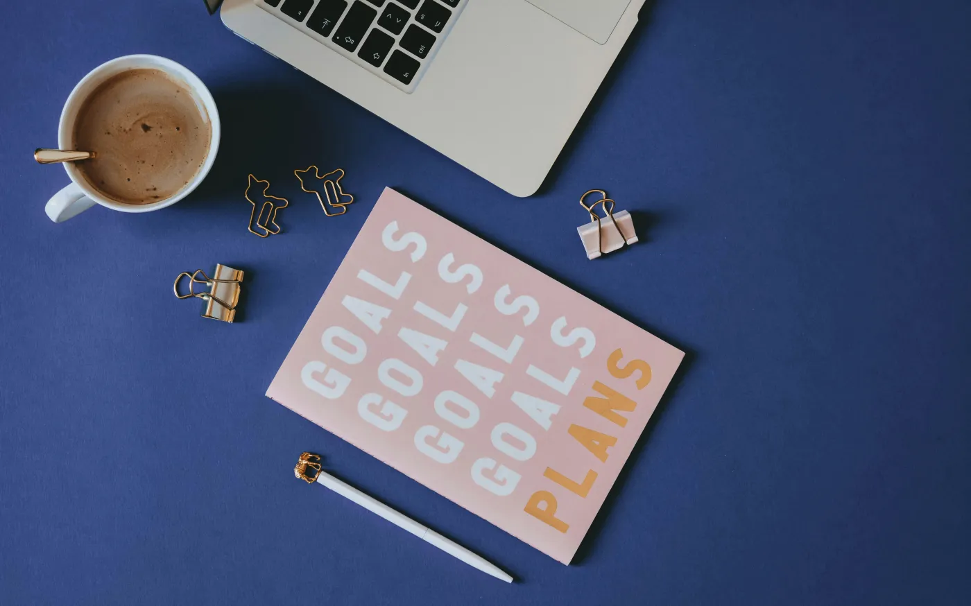 white and brown computer keyboard beside white ceramic mug on blue table by Content Pixie courtesy of Unsplash.
