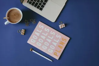 white and brown computer keyboard beside white ceramic mug on blue table by Content Pixie courtesy of Unsplash.