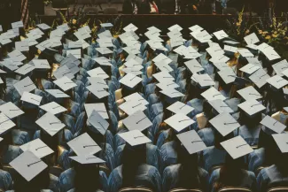blue and white academic hat by Joshua Hoehne courtesy of Unsplash.