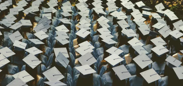 blue and white academic hat by Joshua Hoehne courtesy of Unsplash.
